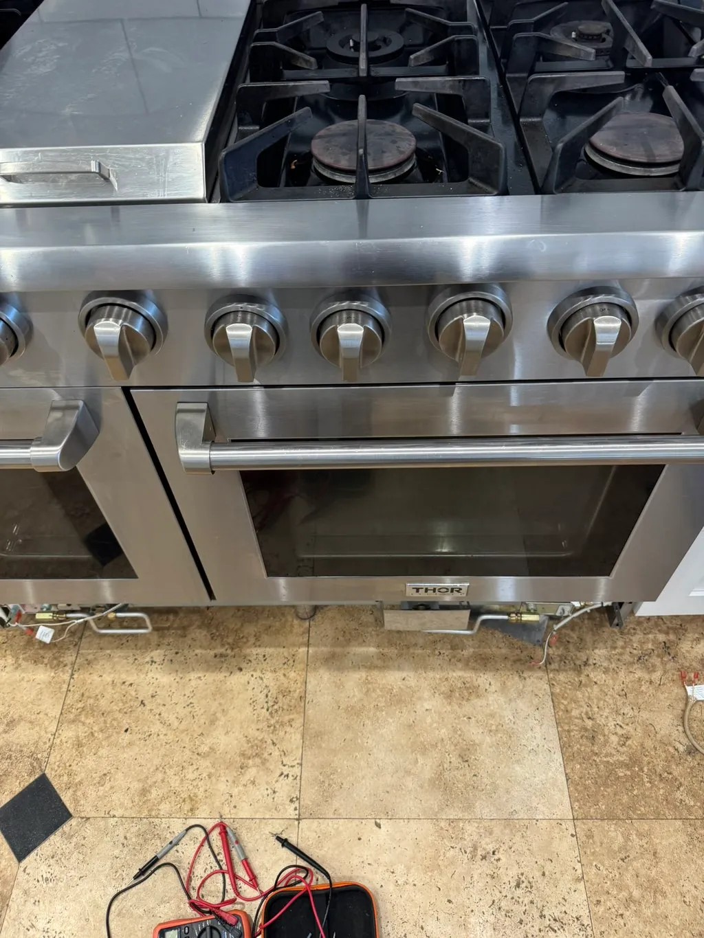Stainless steel Thor gas range and oven pulled out for diagnosis